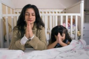 Parent praying with child